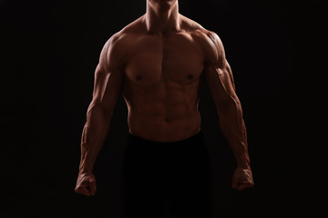 Muscular bodybuilder on dark background