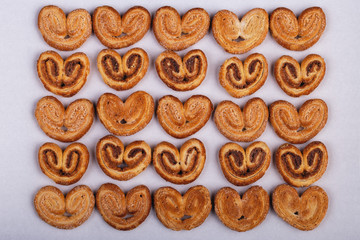 group of sugar cookies in the shape of a heart on a light background.
