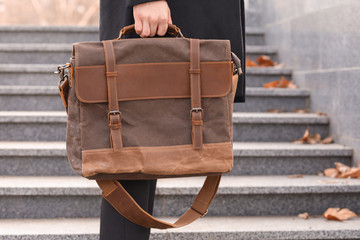 Businessman with stylish briefcase near stairs outdoors