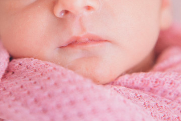 portrait of newborn baby. nose and lips close up. Concept of healthcare: diseases of the ENT, lips, mouth