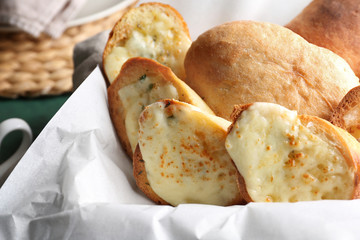Sliced bread with garlic and cheese on table