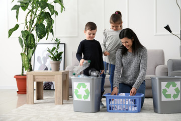 Family sorting garbage at home. Concept of recycling - obrazy, fototapety, plakaty