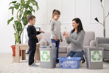 Family sorting garbage at home. Concept of recycling