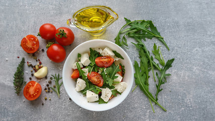 Italian cuisine. Vegetarian food. Salad with mozzarella, arugula and cherry tomatoes.