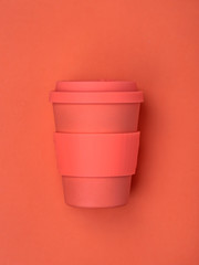 Bright coral-colored coffee cup.