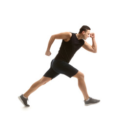 Sporty young man running against white background