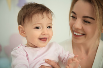 Mother with cute baby girl at home