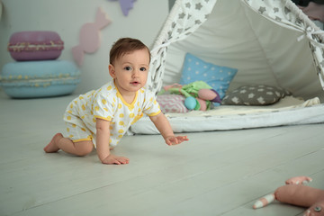 Cute baby girl crawling on floor