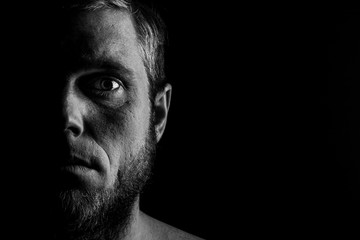 Portrait of a man with a beard on a black background