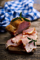 The cut  a smoked pork on a wooden table
