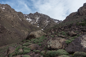 Toubkal national park in springtime with mount, cover by snow and ice, valley near Refuge Toubkal, start point for hike to Jebel Toubkal, highest peak of Atlas mountains and Morocco