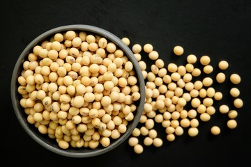 Soybeans in black bowl and black background. 