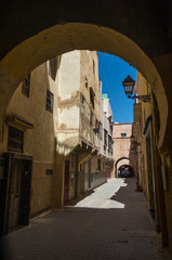Narrow street in medina of medieval imperial city of Meknes. Morocco.