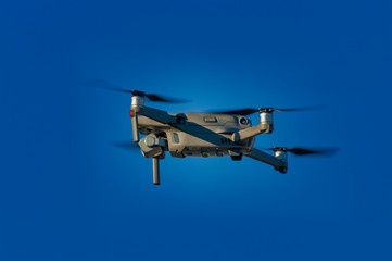 drone flying overhead against blue sky