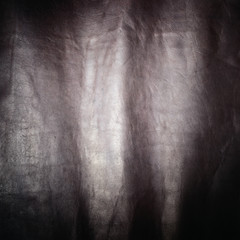 dark brown animal leather texture material with shine background
