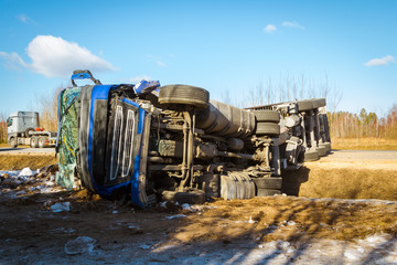 Fototapeta na wymiar Car accident on a road in February 22, 2019, cargo vehicle drove off the road and turned upside down