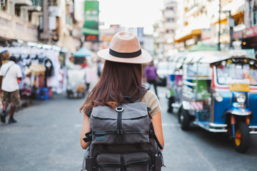 Back view Asian woman tourist backpacker travel in Khao San road, Bangkok, Thailand