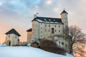 A beautifully restored royal castle Bobolice in a winter aura, sunset, Trail of the Eagles' Nests, Poland