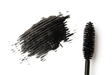 black mascara stroke and make up brush isolated on white background