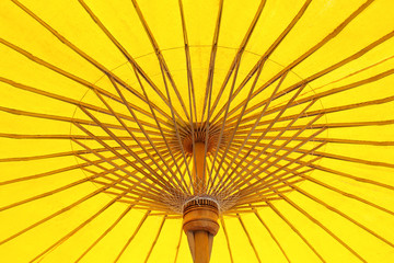 Patterns of colorful under open yellow fabric umbrella texture structure abstract with reflection from the sun for wood structure background
