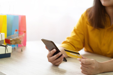 Fototapeta premium woman using credit card shopping online with mobile smartphone