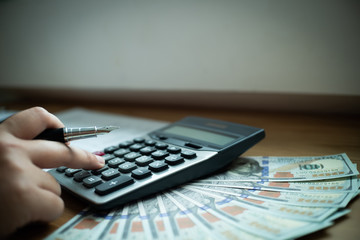 close up of financial inspector calculating fee, tax, valuation in an office