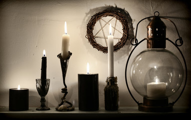 Vintage lamp, weird candles and pentagram on the wall. Magic gothic ritual. Wicca, esoteric,...