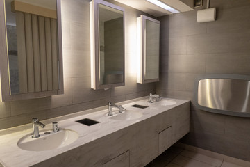 Luxury marble basin with light in mirror in public toilet