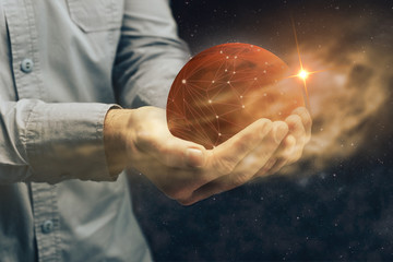Man holding New Home Mars. Mixed media.
