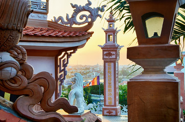 View of the city of Phan Thiet through the sculptural compositions of Buddhist temple Buu Son. Binh Thuan, Vietnam.
