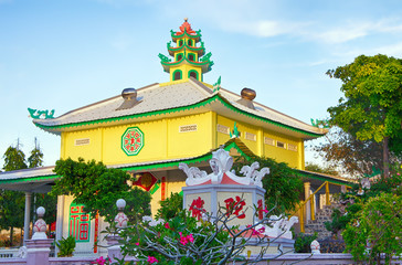 Buddhist temple Linh Long lit by sunset. Mui Ne village, Binh Thuan, Phan Thiet, Vietnam.