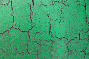 close up broken surface of deteriorating green tennis court floor. background and sports concept.