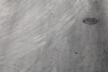 Round hatch in urban asphalt road
