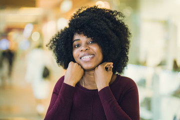 Pretty african young lady shopping in mall.