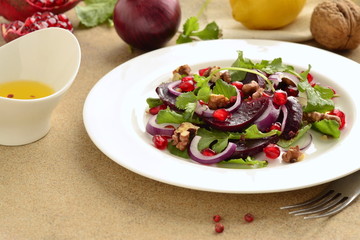 Beetroot salad with arugula, walnuts and pomegranate seeds