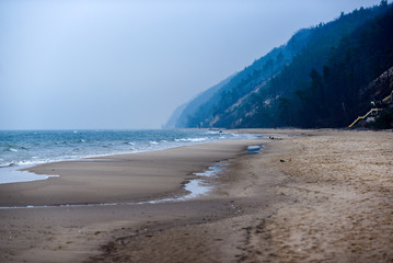 Beach during a cloudy day and fog, sea landscape.