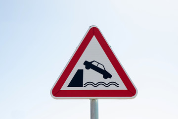 Warning sign with unprotected quayside