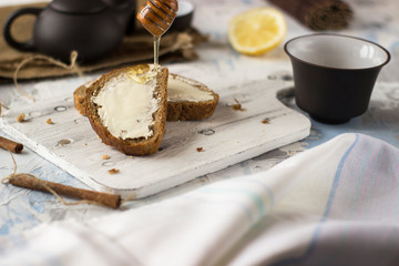 Pieces of bread with butter and honey