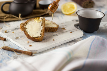 Pieces of bread with butter and honey