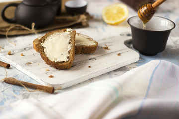 Pieces of bread with butter and honey