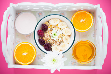 Delicious and healthy breakfast on a white tray. Space for a text. Top view.