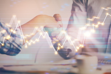 double exposure of handshake and business charts. Partnership concept.
