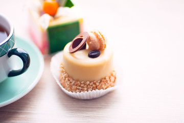 Food concept. Cakes and cup of delicious tea for happy day. Top view. Space for a text.