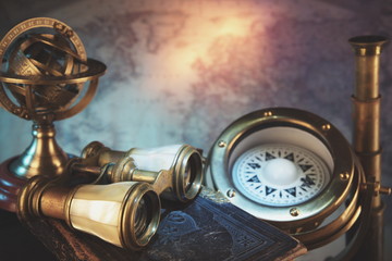 Zodiac globe,astrological.Antique ship compass.Old Logbook,binoculars and monoculars telescope.Pirate world map.Travel and marine engraving background. Treasure hood concept.Retro and vintage style.