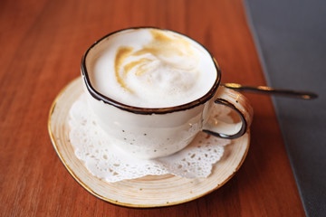 coffee cup latte art in cafe, close up