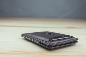 brown wallet with money .
