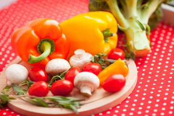 Healthy food concept. Fresh organic vegetables on the red polka-dot background. Ingredients for cooking. Close up. Top view.