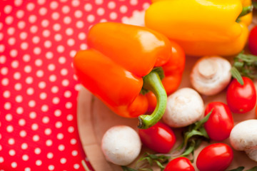 Healthy food concept. Fresh organic vegetables on the red polka-dot background. Ingredients for cooking. Close up. Top view.