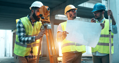 Portrait of construction engineers working on building site