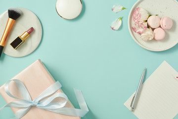 Makeup cosmetic products color background flat lay top view. woman beauty fashion decorative. bow gift set